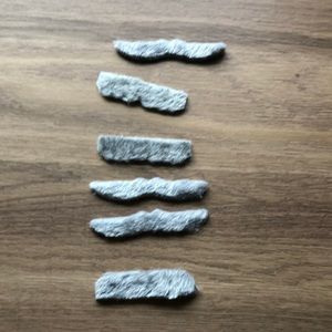 Lot of six peel and stick obviously fake mustaches in gray